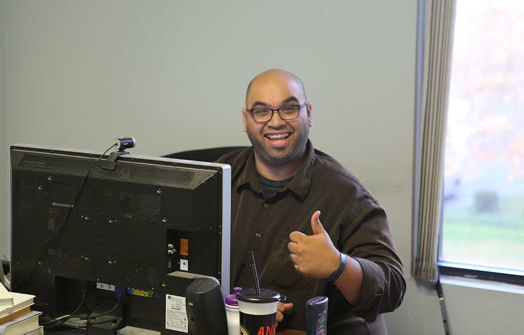 John Rowa giving a thumbs up at Riverside office