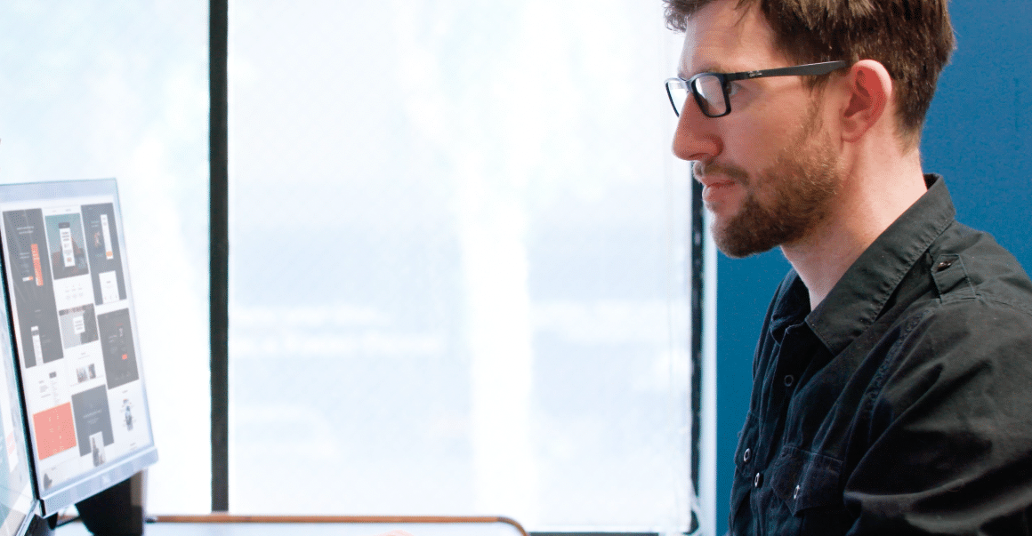 man at a desk builds a website with SEO best practices
